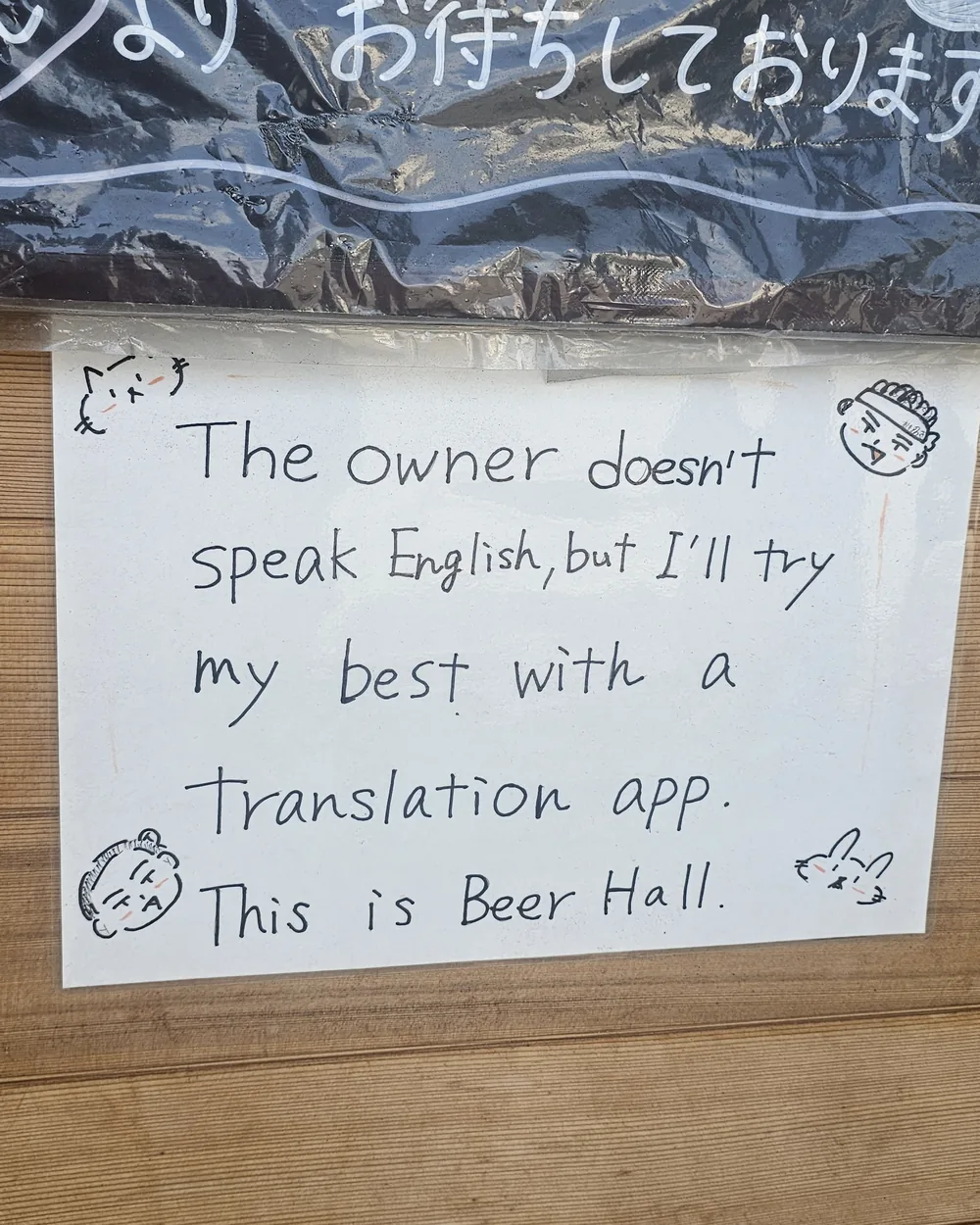 Mot manuscrit affiché dans un bar : « The owner doesn't speak English, but I'll try my best with a translation app. This is Beer Hall »